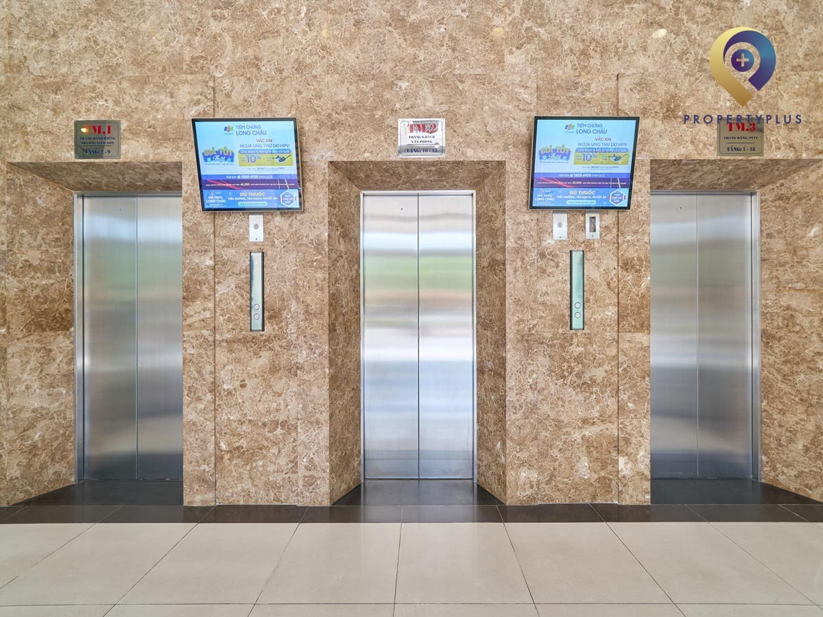 Elevators inside Sun Square building with modern design and digital screens